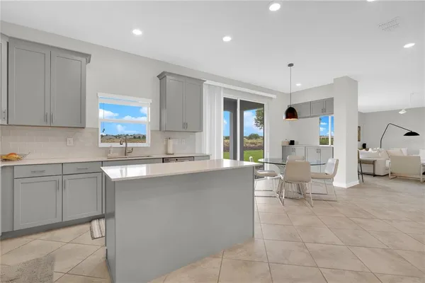 a large white kitchen with a large window