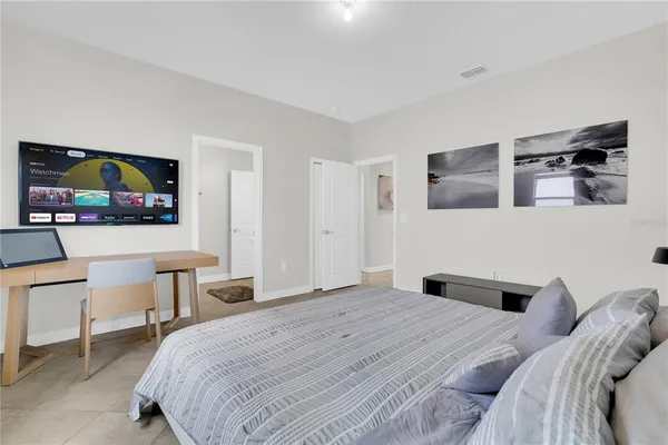 a bedroom with a bed and a television