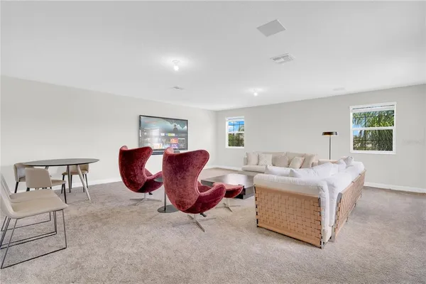 a living room with furniture a window and a lamp