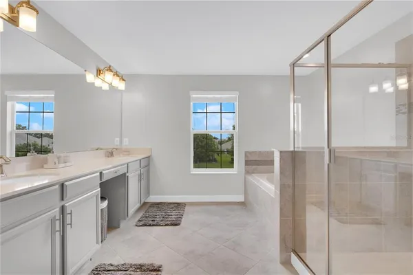 a bathroom with a double vanity sink a toilet and a shower