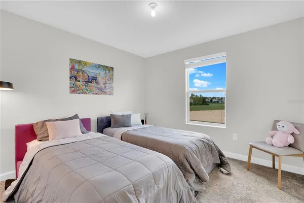 a bedroom with a bed and a painting on the wall
