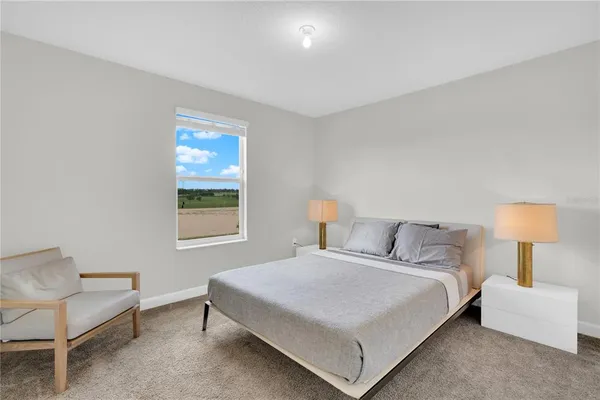 a bedroom with a bed and a lamp
