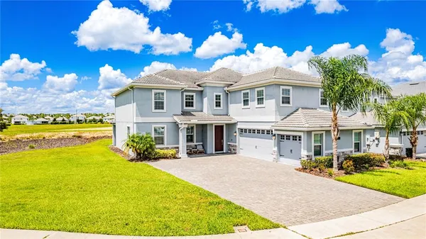 a front view of a house with a big yard