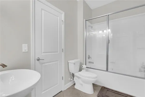 a bathroom with a toilet a sink and shower