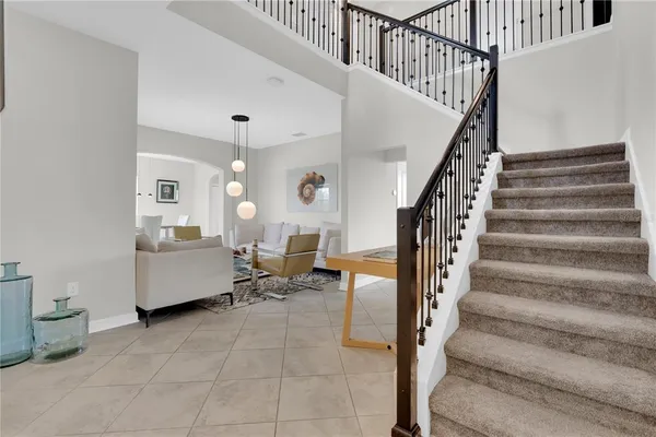 a living room with furniture and a chandelier