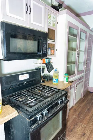 a stove top oven sitting inside of a kitchen