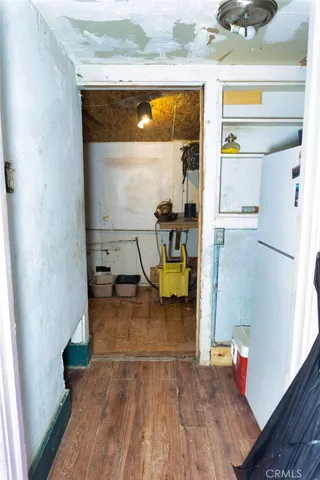a kitchen with cabinets and wooden floor