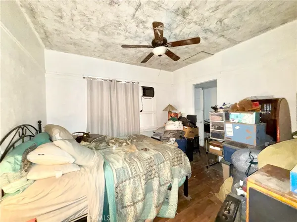 a bed room with a bed mirror and a chandelier