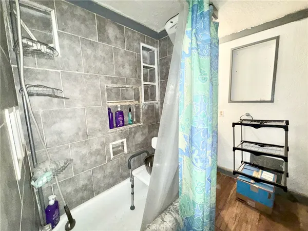 a bathroom with a bathtub and shower