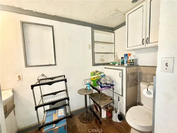 a bathroom with a toilet a sink and a window