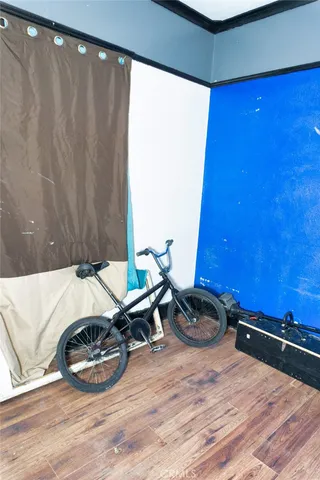 a bedroom with bed and a mirror