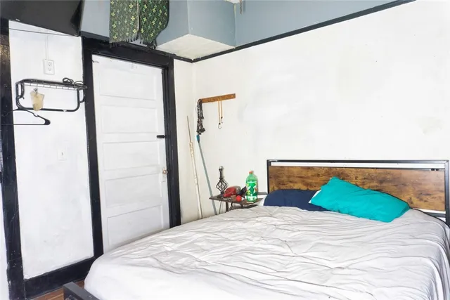 a bedroom with a bed and glass walk in closet