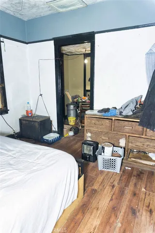 a bedroom with a bed and a mirror