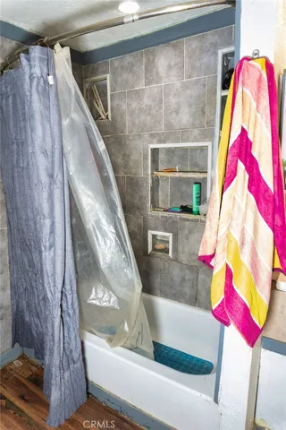 a view of a room with wooden floor and bench