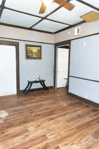 a view of a room with wooden floor
