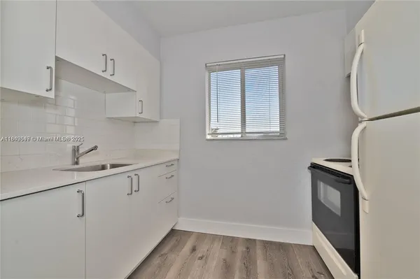 a view of a kitchen with sink and dishwasher