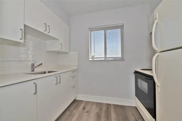 a view of a kitchen with sink and dishwasher