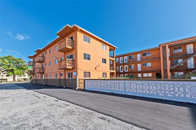 a view of a house with wooden fence