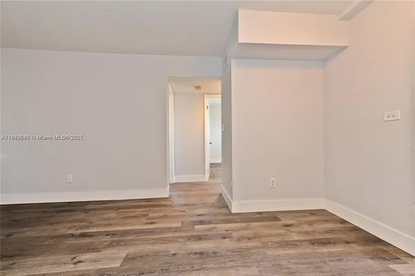 a view of a room with wooden floor
