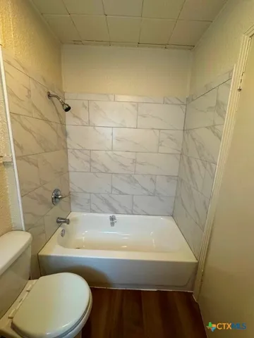 a view of hallway with wooden floor