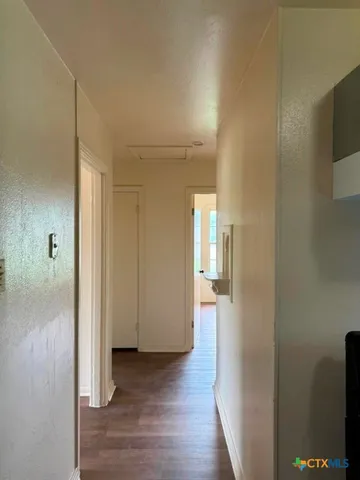a view of a room with wooden floor