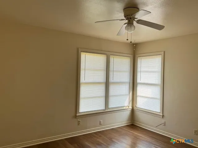 wooden floor and window in an empty room