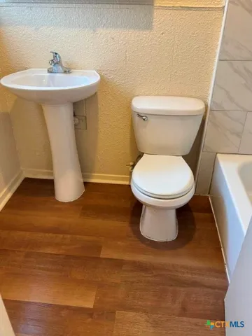 a view of an empty room and wooden floor