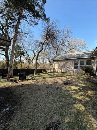 a view of a yard with a house and a tree