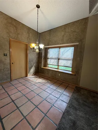 a room that has a window and a chandelier