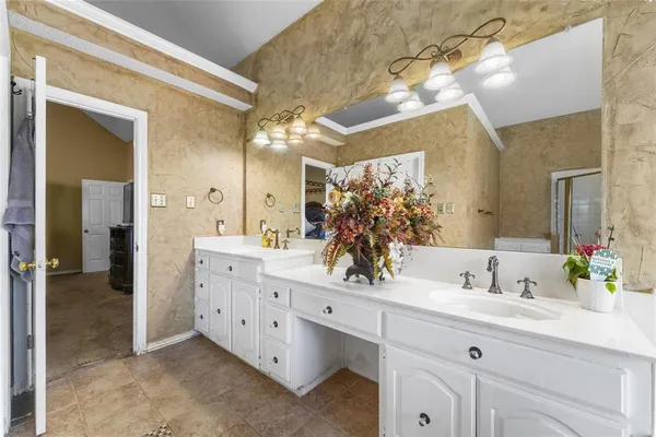 a bathroom with a double vanity sink mirror and shower