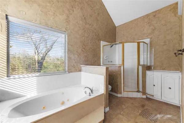 a bathroom with a bathtub and a shower