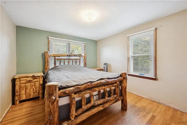 a bedroom with a bed next to a window