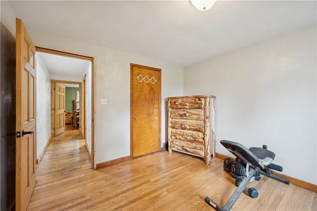 an empty room with furniture and wooden floor
