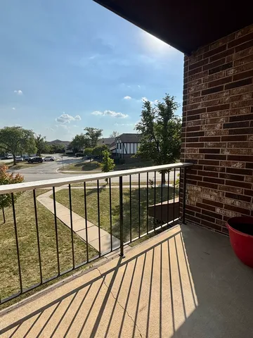 a view of balcony with wooden floor and fence