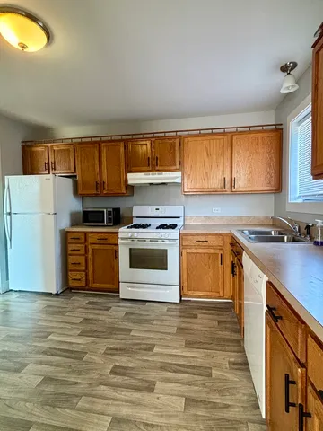 a kitchen with a stove a sink and a refrigerator