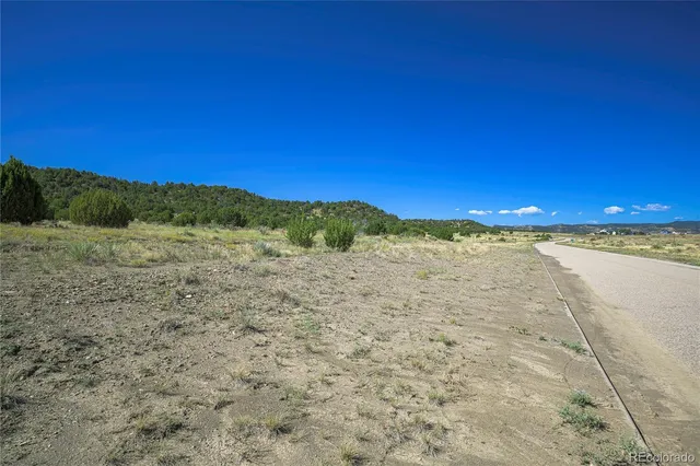 a view of a road with mountains in the background