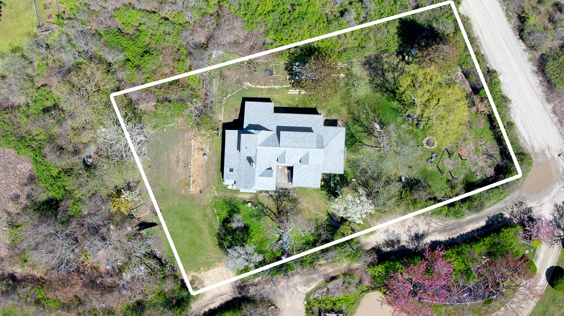 23 Dukes Road Nantucket, MA 02554 - Photo 1 of 6 a view of a house with a flower garden