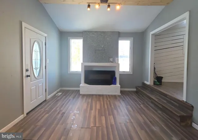 wooden floor in an empty room with a fireplace