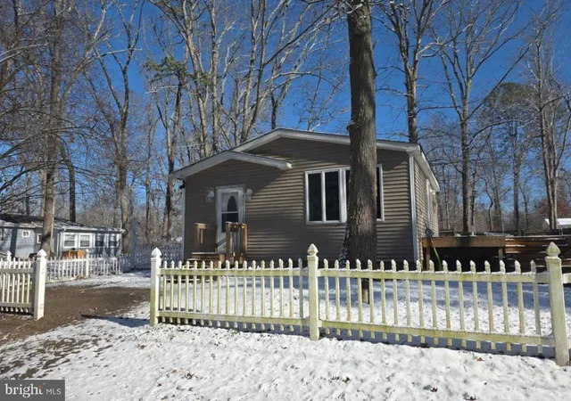 a front view of a house with a fence