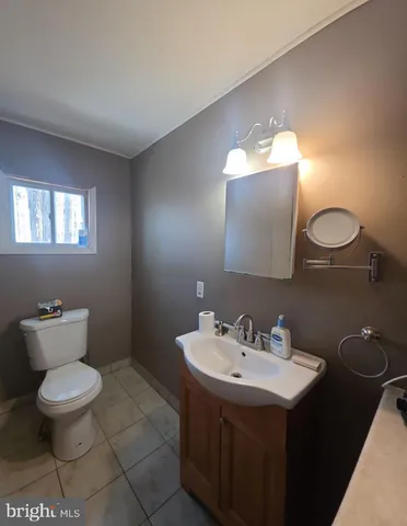 a bathroom with a sink toilet and a mirror