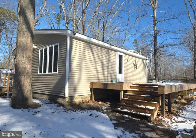 a view of house with backyard and sitting area