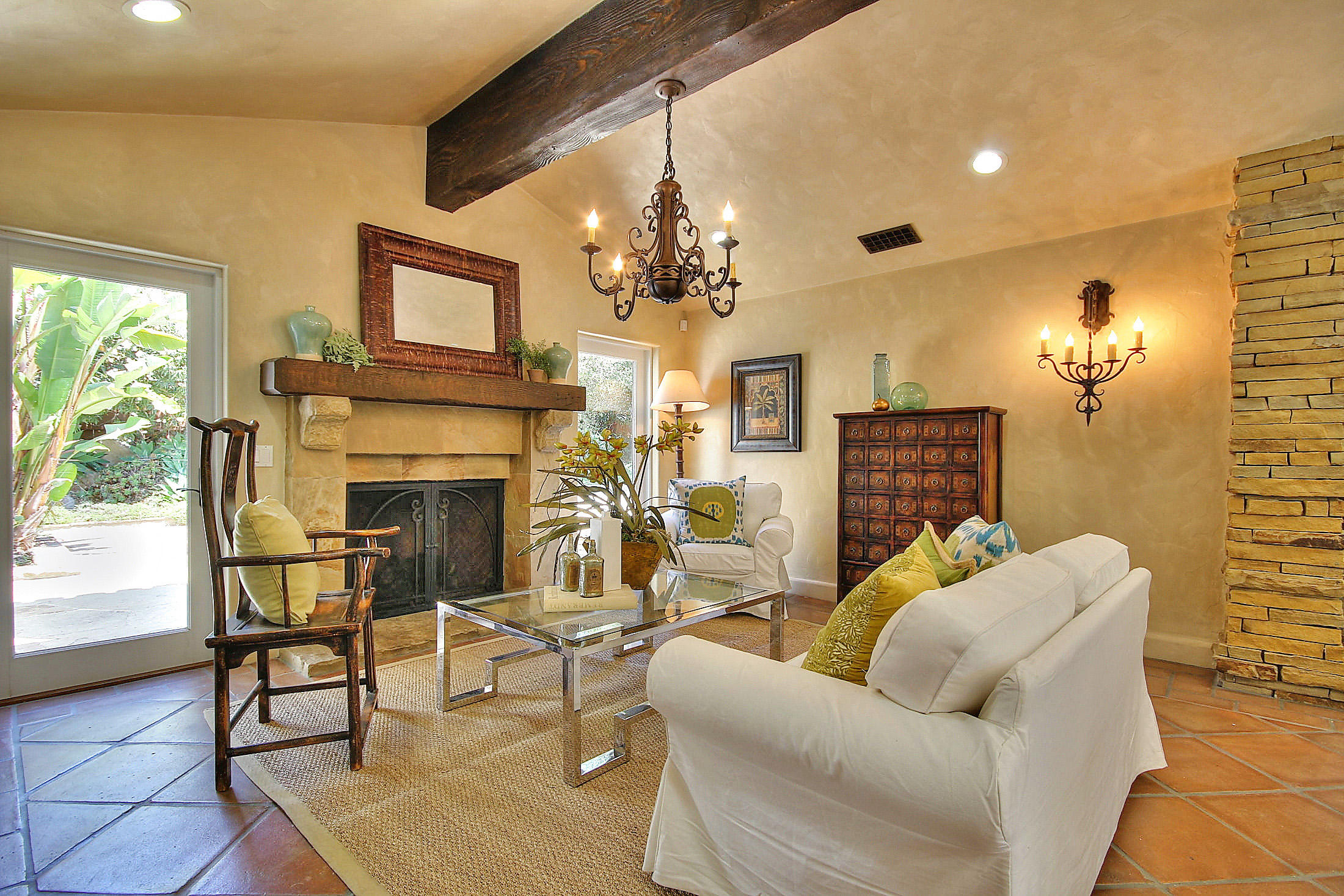 2540 Foothill Road Santa Barbara, CA 93105 - Photo 19 of 45 a living room with furniture a chandelier and a fireplace