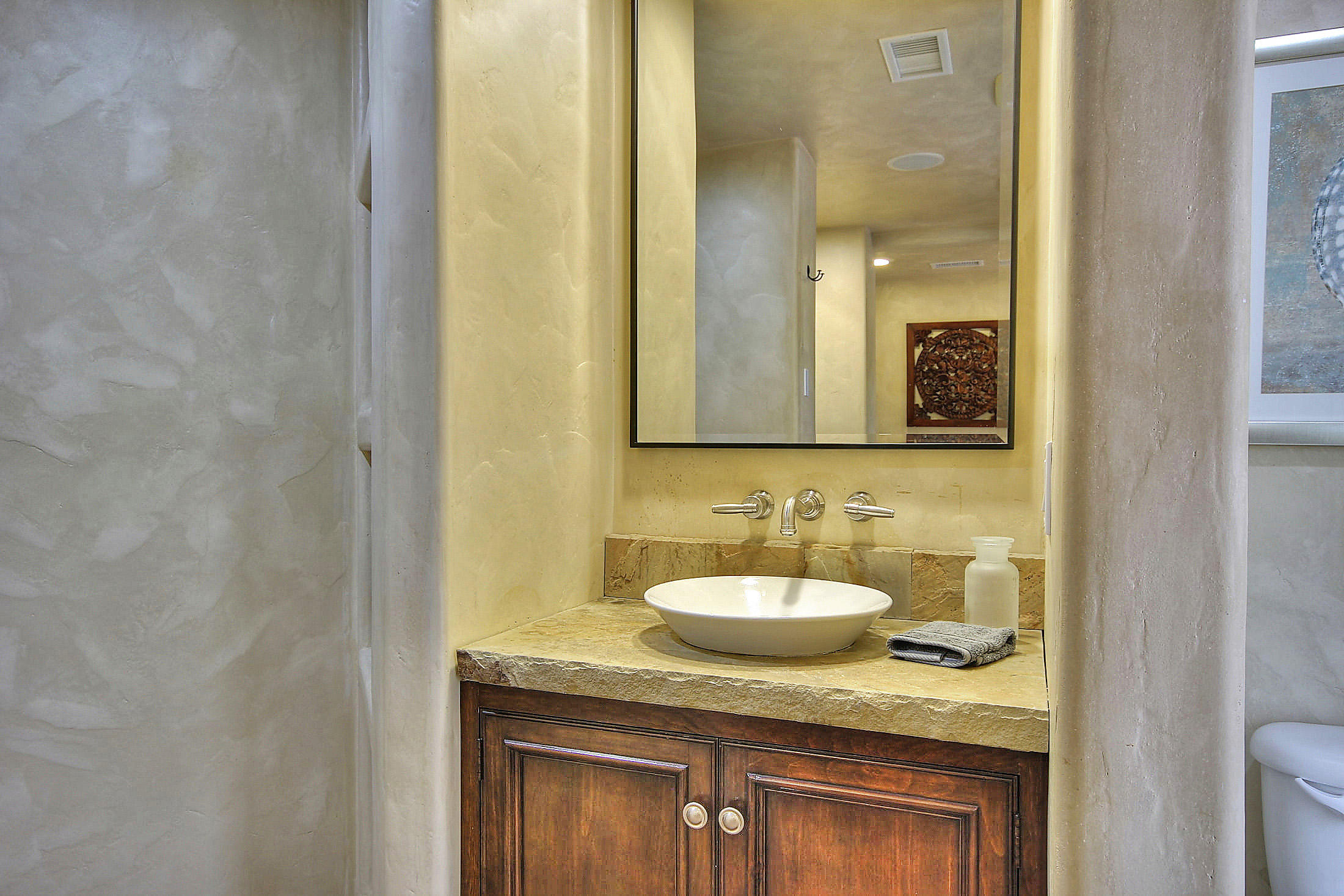 2540 Foothill Road Santa Barbara, CA 93105 - Photo 35 of 45 a bathroom with a granite countertop sink and a mirror