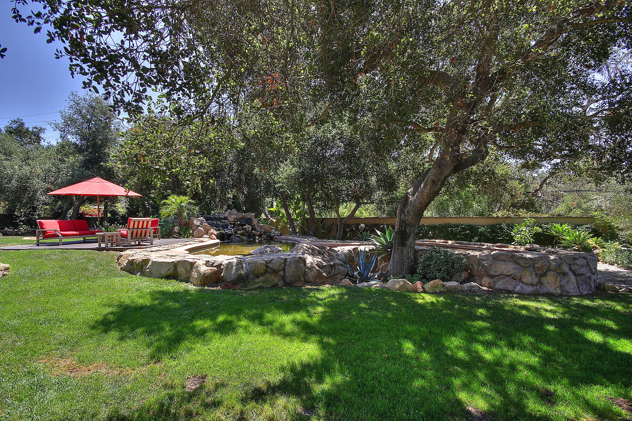 2540 Foothill Road Santa Barbara, CA 93105 - Photo 4 of 45 a view of a swimming pool with lawn chairs under an umbrella