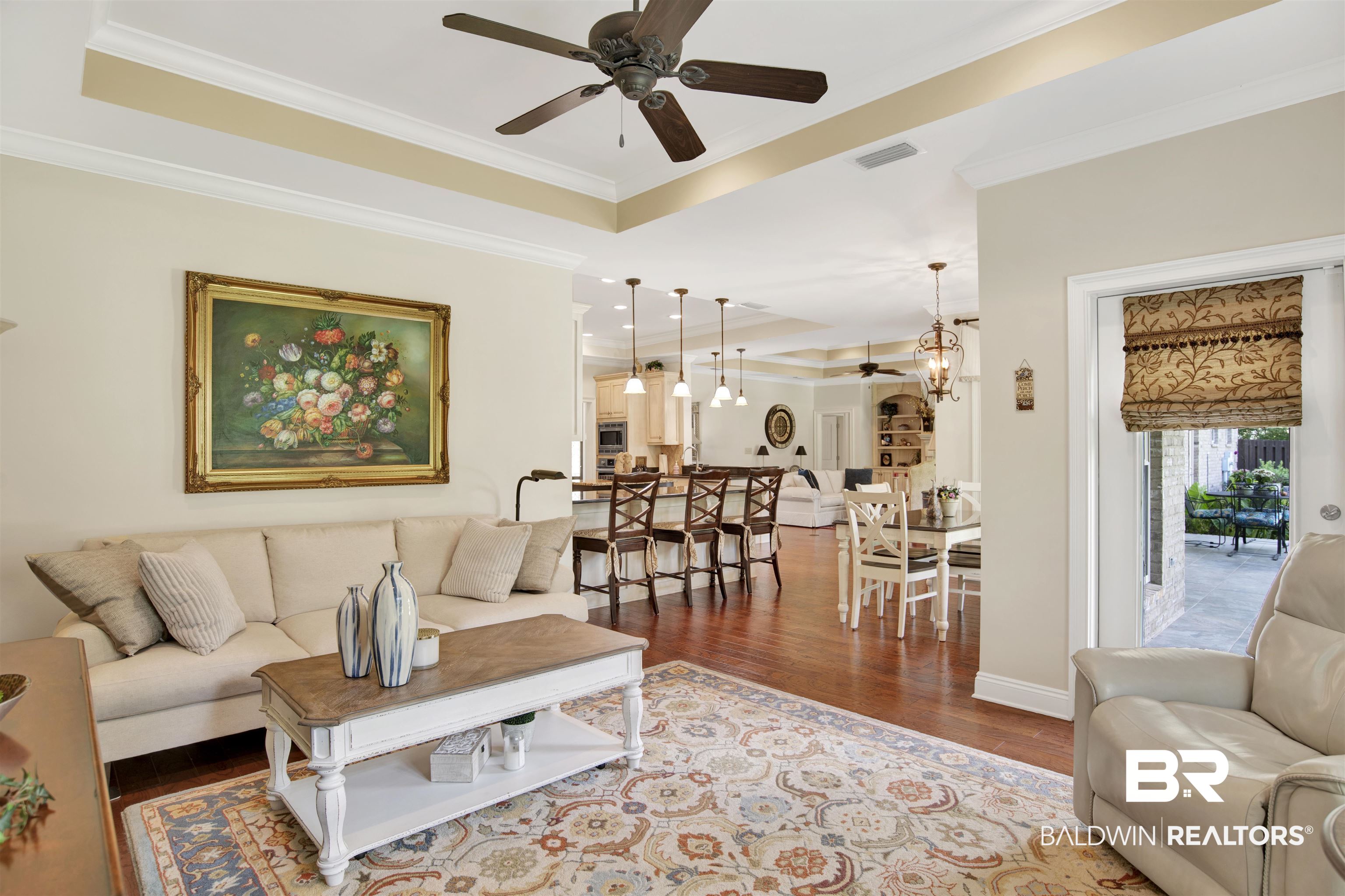 8358 Forest Lane Foley, AL 36535 - Photo 31 of 46 Living room with ceiling fan, a tray ceiling, wood finished floors, and ornamental molding