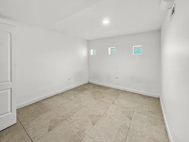 an empty room with a empty space and windows