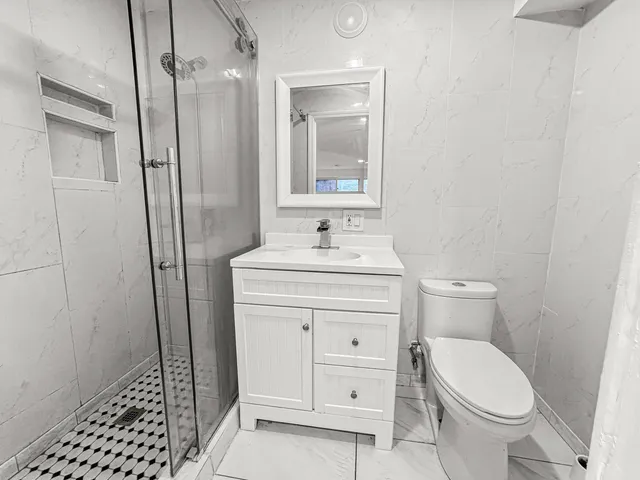 a bathroom with a sink toilet and shower