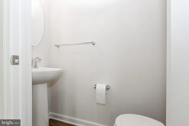 a bathroom with a sink mirror and toilet