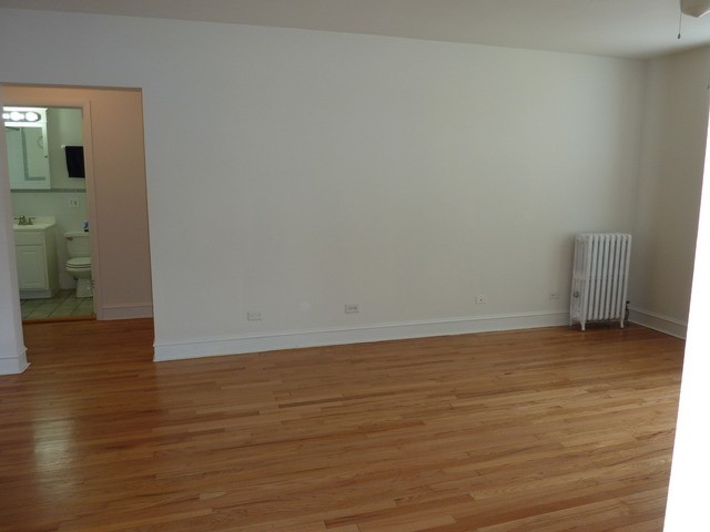 5058 North Claremont Avenue, Unit 2E Chicago, IL 60625 - Photo 11 of 12 a view of an empty room and wooden floor