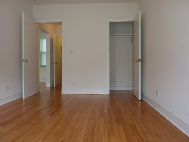 5058 North Claremont Avenue, Unit 2E Chicago, IL 60625 - Photo 9 of 12 an empty room with wooden floor & closet area